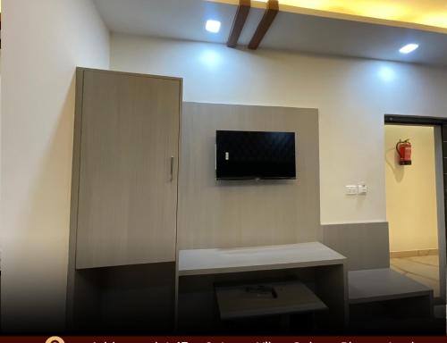 a bathroom with a partition with a tv on the wall at hotel k stay by Anmol in Haridwār