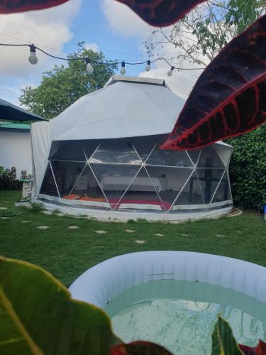 a tent is set up in a yard at Paraiso Tropical Glamping in San Antonio