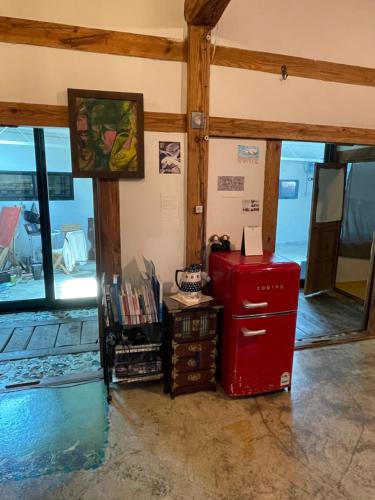 a room with a red refrigerator in a room with windows at Alleyway 모퉁이 in Jeonju