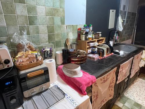 a kitchen with a counter top with a sink and a stove at Alleyway 모퉁이 in Jeonju