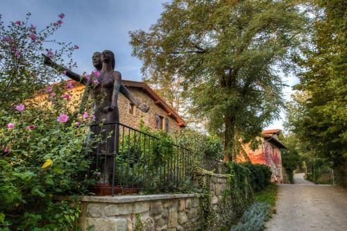 a statue of a girl on a fence in front of a house at Fattorie di Celli in Poppi