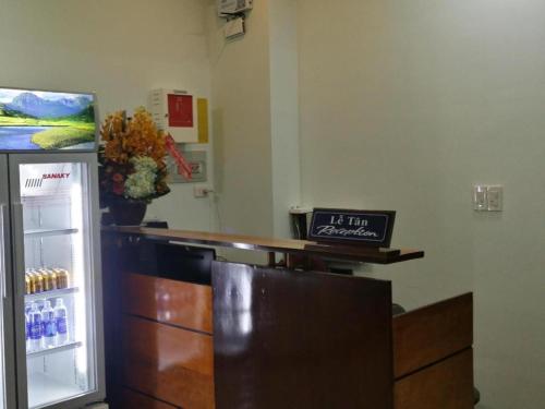 a bar with a refrigerator with a clock on it at Bong Mai Motel in Da Nang
