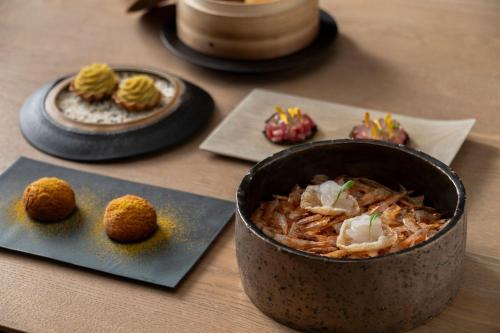 a bowl of food on a table with plates of food at River Retreat Garaku in Toyama