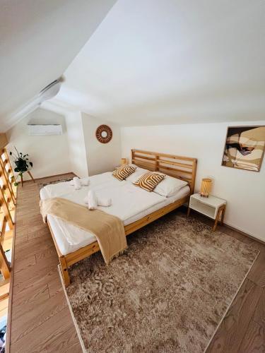 a bedroom with a large bed in a room at Apartmán MiLoo in Mikulov
