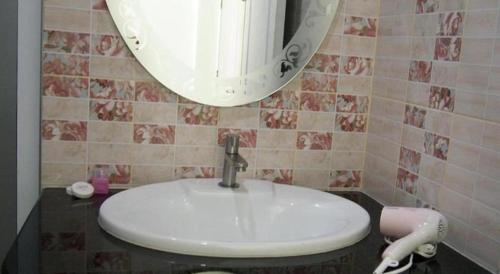a bathroom with a white sink and a mirror at Lake Terrace Resort in Ban Pak Ba Ra