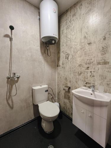 a bathroom with a toilet and a sink at Albatross Family Nest Breeze Bungalow in Varna City