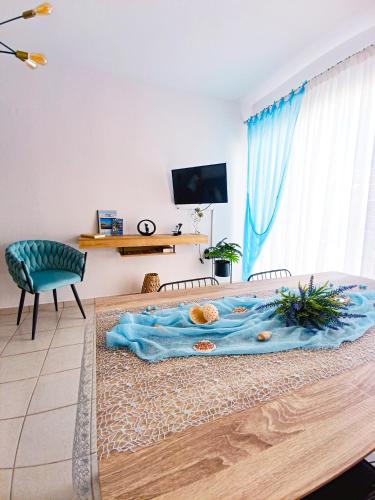 a room with a bed with a blue blanket on it at Seaside Breeze Apartment in Sitia
