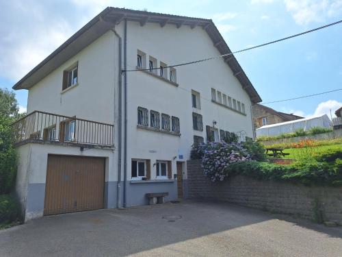 a large white house with a garage at L'Aubier in Saint-Maur