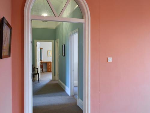 an arched doorway into a hallway with green and orange walls at Apartment 3-Uk33247 in Grayrigg