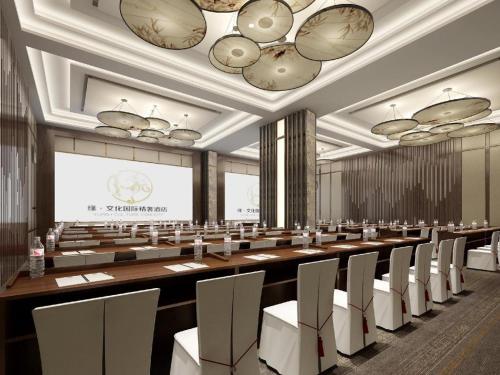 a conference room with a large table and chairs at Yuan Culture Hotel Shenzhen World Shajing in Shenzhen