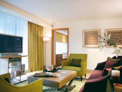a living room with a couch and a tv at Taj Wellington Mews, Mumbai in Mumbai