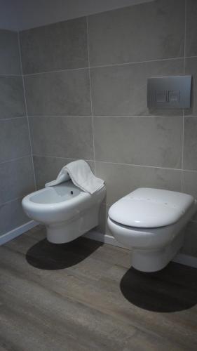 a bathroom with a toilet and a bidet at Hotel Europa in Marostica