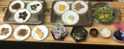 a table with plates of food and bowls of food at Ueno Frex Hotel in Iga