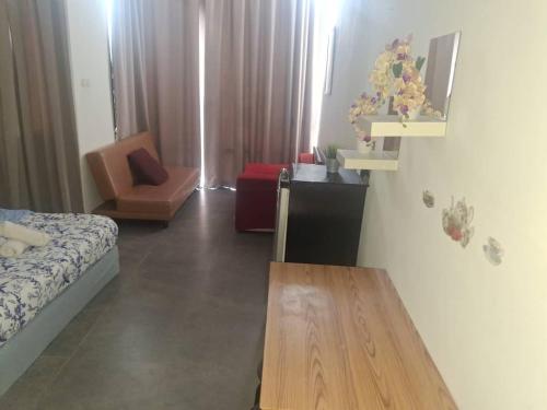 a living room with a bed and a table at Studio B, Empire Damansara in Petaling Jaya
