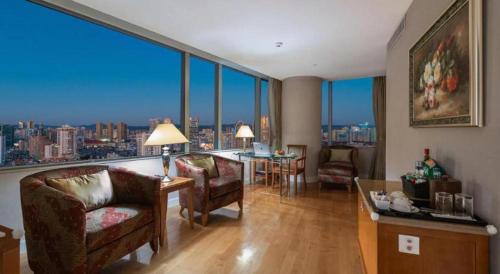 a living room with a view of a city at Kai Wah Plaza International Hotel in Kunming