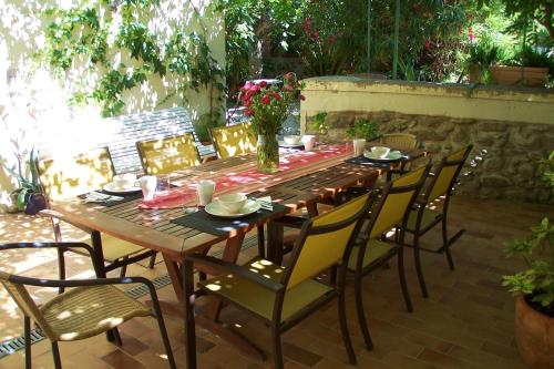 a wooden table and chairs on a patio at Maison 225 in Prades