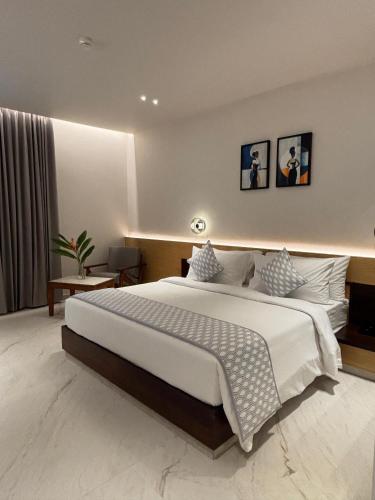 a bedroom with a large bed in a room at Arcor Hotels in Mysore