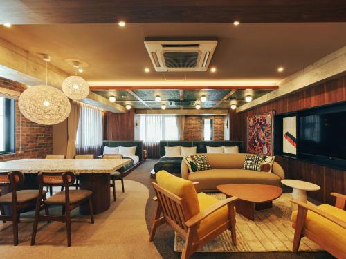 a living room with a couch and a table at illi Rug Hamamatsucho in Tokyo