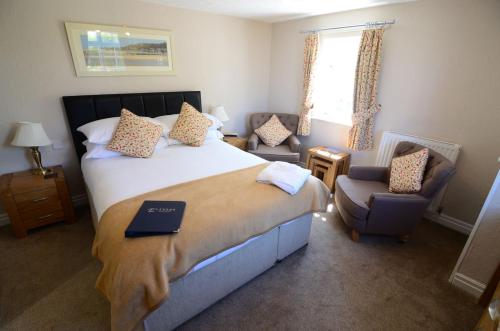 a bedroom with a bed with a book on it at Ellerby Country Inn in Ellerby