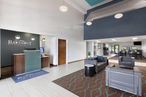 an office lobby with a barinant sign on the wall at Baymont by Wyndham Moss Point in Moss Point