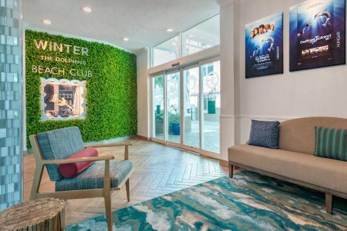 a living room with two chairs and a couch at Winter the Dolphin's Beach Club, an Ascend Collection Hotel in Clearwater Beach