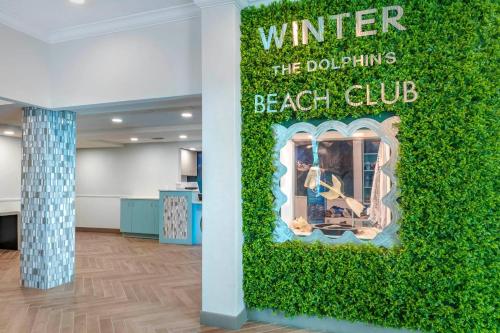 a green wall in the lobby of a beach club at Winter the Dolphin's Beach Club, an Ascend Collection Hotel in Clearwater Beach