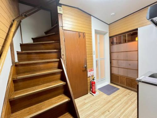 a room with stairs leading up to a kitchen at Akabane Nishi kodate AN1 in Wada