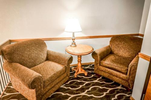 two chairs and a table with a lamp in a room at Quality Inn Selinsgrove in Selinsgrove