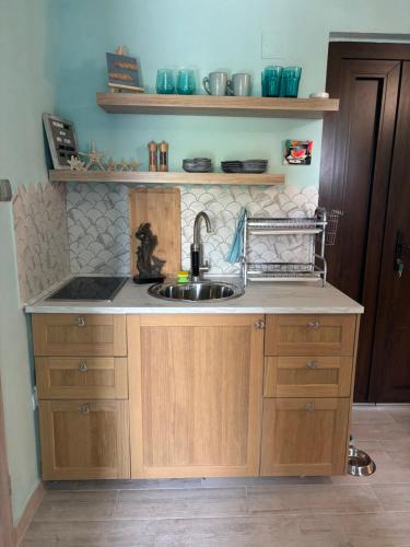 a kitchen with a sink and a counter at Mermaid Cove in Sukošan