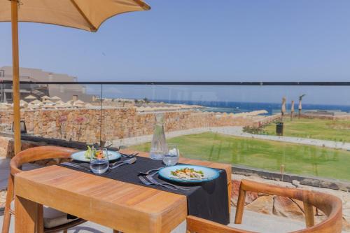 a table with a plate of food and an umbrella at Aldiana Club Naga Bay in Hurghada