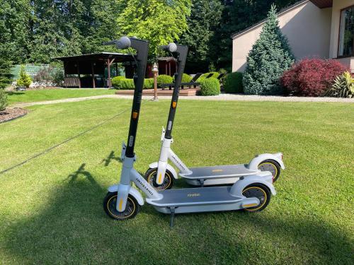a scooter parked on the grass in a yard at Hotel resort Lovecká bašta Strakonice in Strakonice