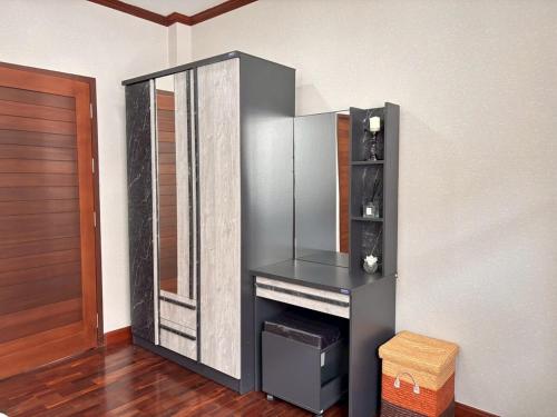 a room with a fireplace and a mirror at The Harmony House in Hat Yai in Ban Thung Ri