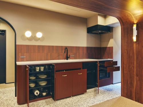 a large kitchen with a counter and a sink at illi Rug Hamamatsucho in Tokyo