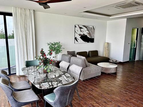 a living room with a couch and a table at Golden Coconut 4 Bed 6 Bath Luxury Sea View Villa in Chaweng Beach, Koh Samui in Amphoe Koh Samui
