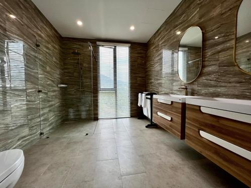 a bathroom with two sinks and a shower at Golden Coconut 4 Bed 6 Bath Luxury Sea View Villa in Chaweng Beach, Koh Samui in Amphoe Koh Samui