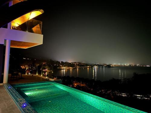 a swimming pool in front of a building at night at Golden Coconut 4 Bed 6 Bath Luxury Sea View Villa in Chaweng Beach, Koh Samui in Amphoe Koh Samui