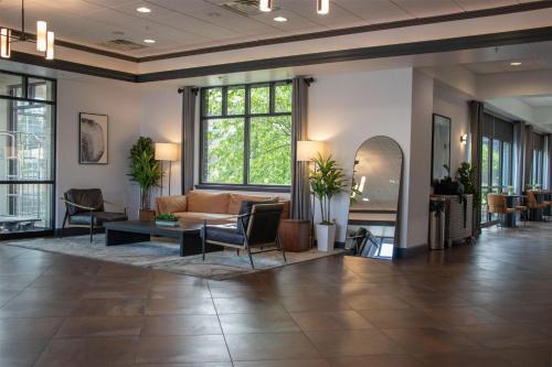 a lobby with a couch and a table at Wyndham Bloomington - Mall of America in Bloomington
