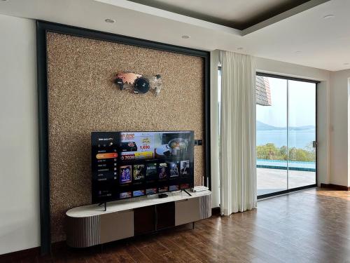 a living room with a flat screen tv on a wall at Golden Coconut 4 Bed 6 Bath Luxury Sea View Villa in Chaweng Beach, Koh Samui in Amphoe Koh Samui