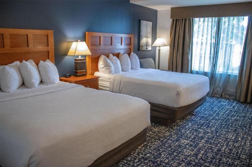 a hotel room with two beds and a window at Wyndham Bloomington - Mall of America in Bloomington