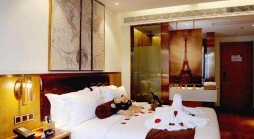 a bedroom with a bed with two teddy bears on it at James Joyce Coffetel· Hefei Anhui Agricultural University in Hefei