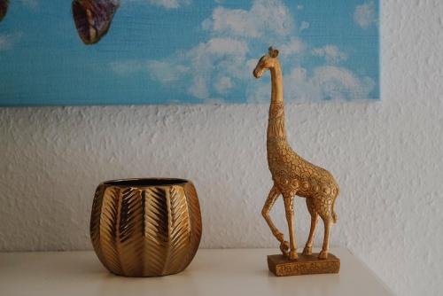 a statue of a giraffe on a table next to a vase at Sonnenberg Domizil in Chemnitz
