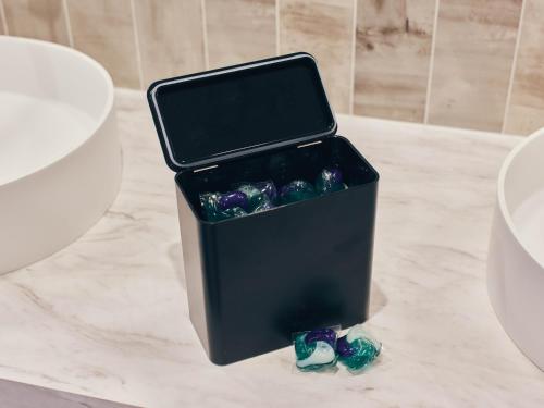 a black container sitting on top of a counter with two shoes at illi Rug Hamamatsucho in Tokyo