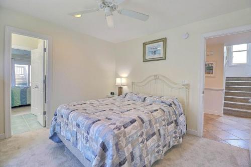 a bedroom with a large bed and a staircase at 7076 - JMJ Seascape in Nags Head