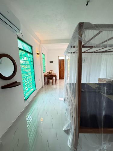 a hallway of a house with a glass wall at Hidden Garden Tangalle in Tangalle