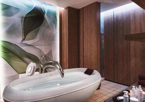 a bathroom with a sink and a bath tub at St George Beach Hotel & Spa Resort in Paphos City