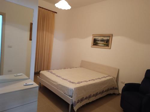 a small bedroom with a bed in a room at Casa Vacanze Salento in Matino