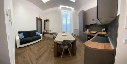 a kitchen and living room with a table and a couch at Belvedere Dei Trabocchi in Ortona