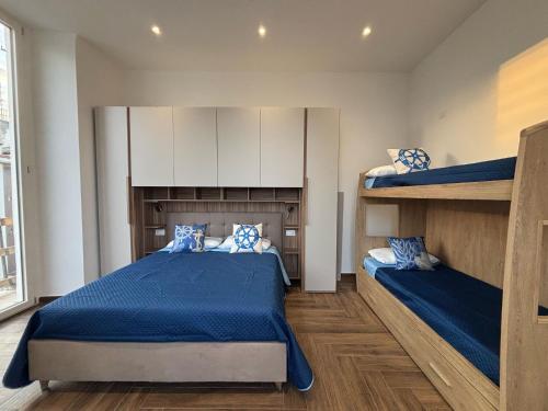 a bedroom with two bunk beds and blue sheets at Belvedere Dei Trabocchi in Ortona