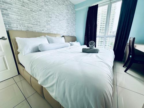 a large white bed in a room with a window at 12pax 3-Bedroom l Seaview l Georgetown l Gleneagles l Mansion One in George Town