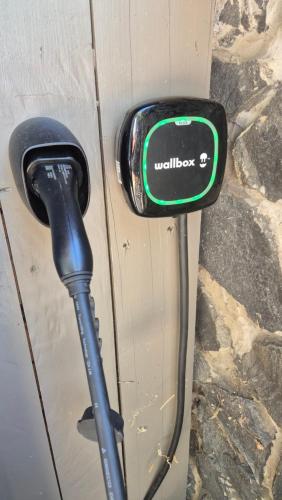 a cord plugged into a door with a toll booth at Zanzara Guesthouse in Pákozd